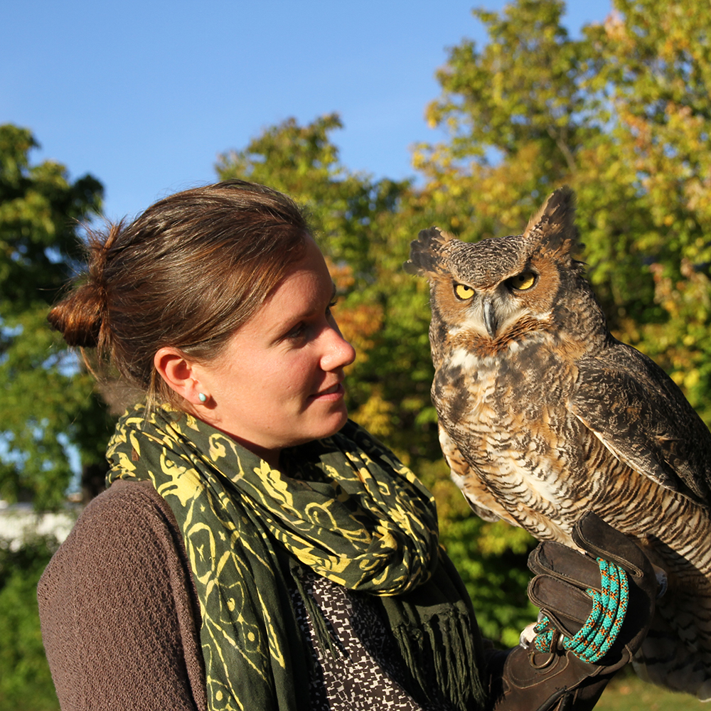 Jenn Bock posing with an owl.