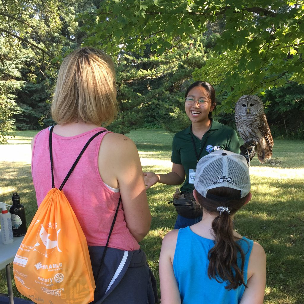 a mother and daughter speak to a presenter with an owl